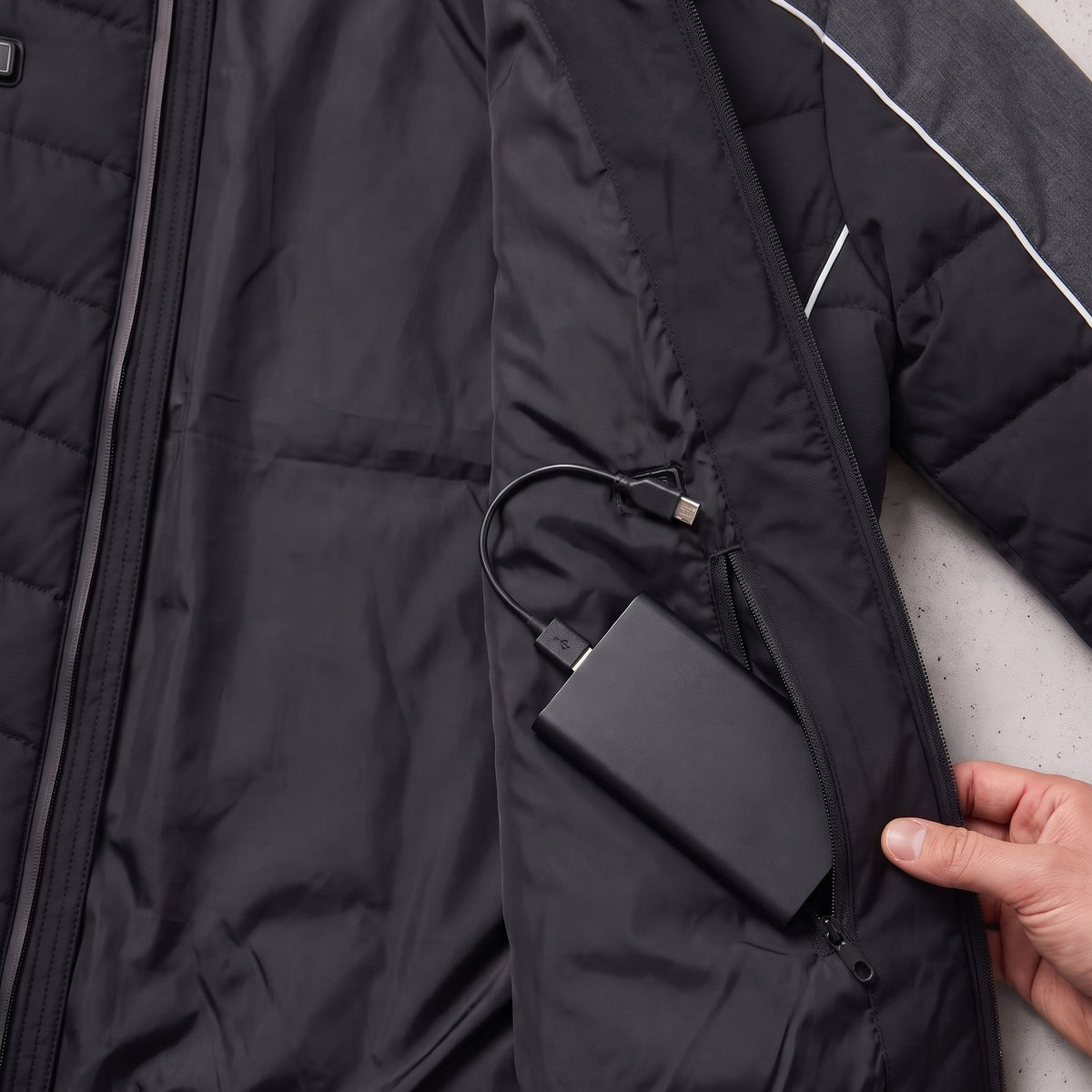 Power bank in the inner zip pocket of the Mercedes-AMG edition heated jacket