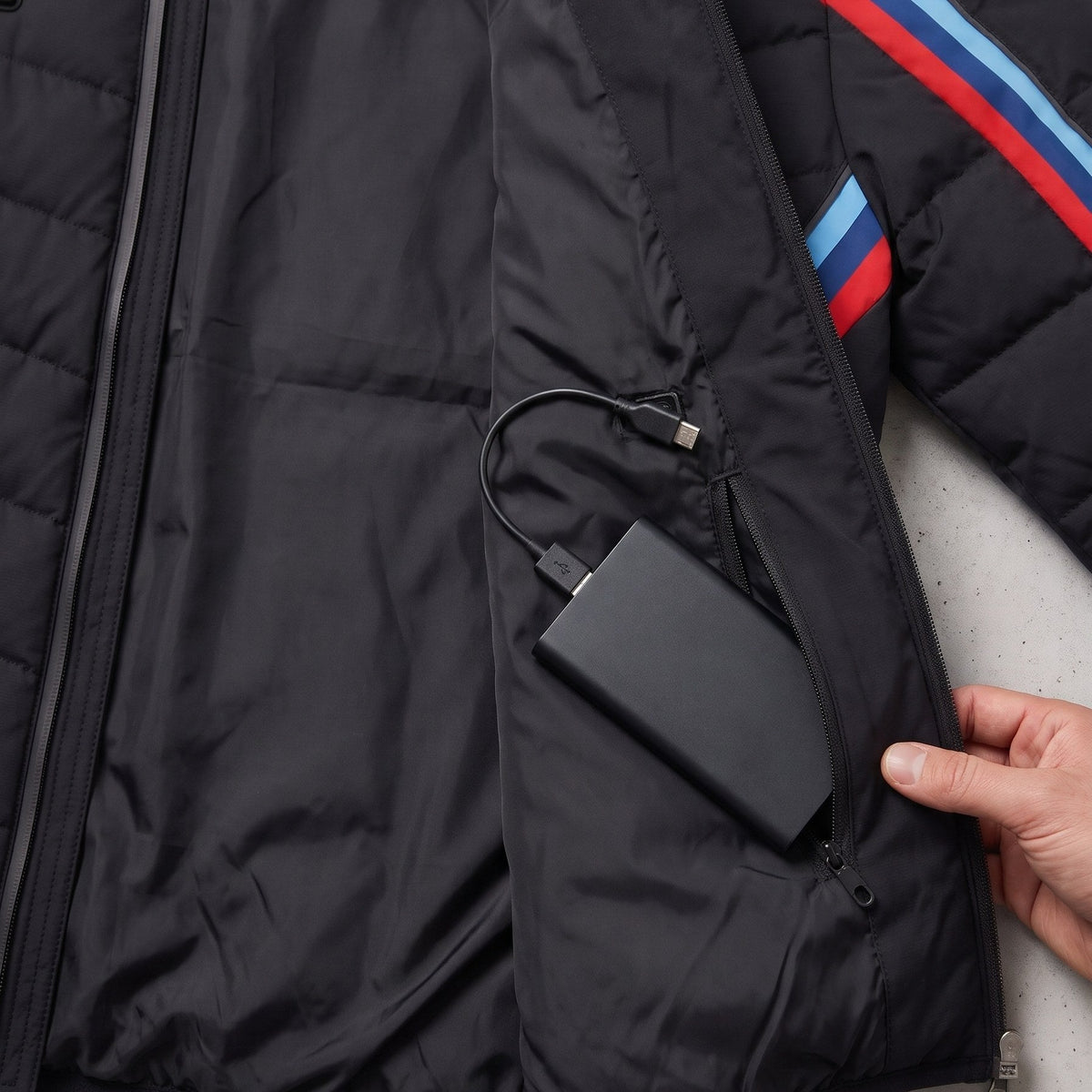 Power bank in the inner zip pocket of the BMW M edition heated jacket