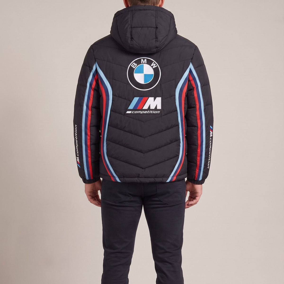 Man wearing the BMW M heated puffer jacket, back view